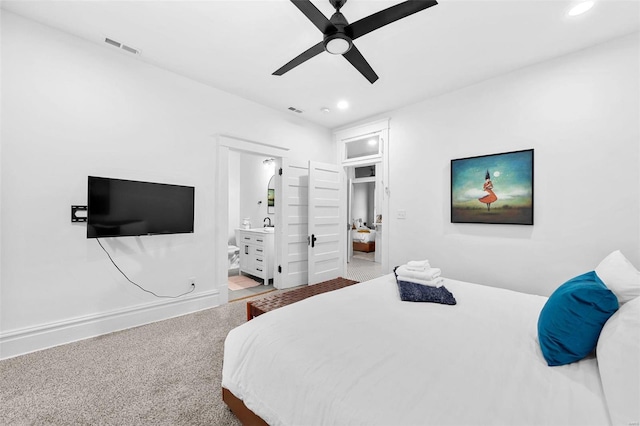 carpeted bedroom with connected bathroom and ceiling fan