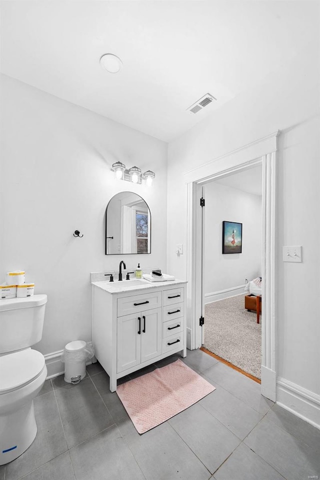 bathroom with vanity, tile patterned floors, and toilet