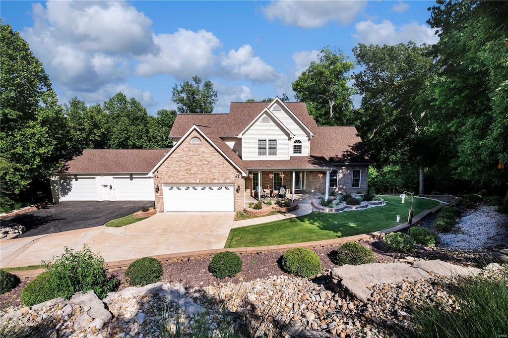 view of front of house with covered porch and a front lawn