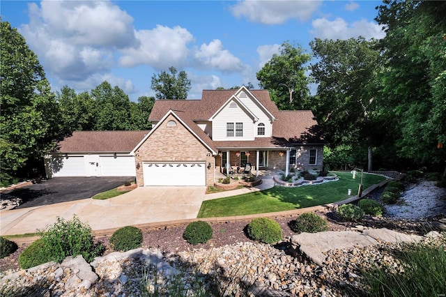 view of front of house with covered porch and a front lawn