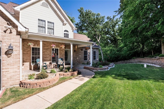 view of front facade featuring covered porch and a front yard