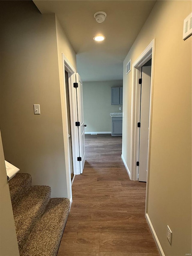 hall with hardwood / wood-style flooring