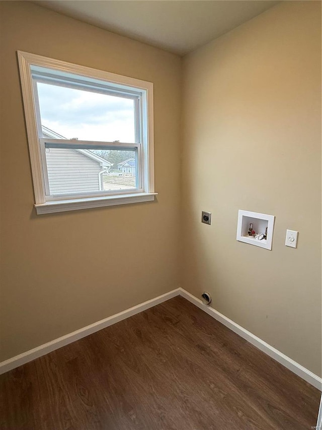 clothes washing area with electric dryer hookup, washer hookup, and hardwood / wood-style flooring