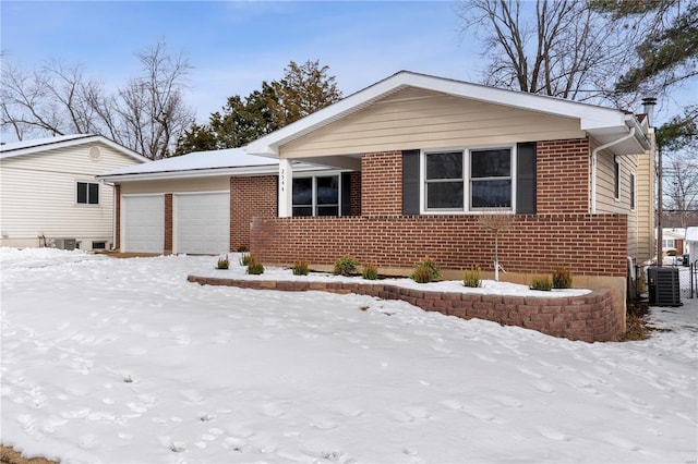 view of front of property featuring central AC and a garage