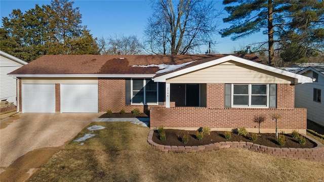 ranch-style house with a garage and a front lawn