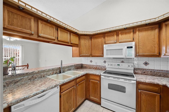 kitchen with backsplash, a textured ceiling, white appliances, sink, and light tile patterned flooring