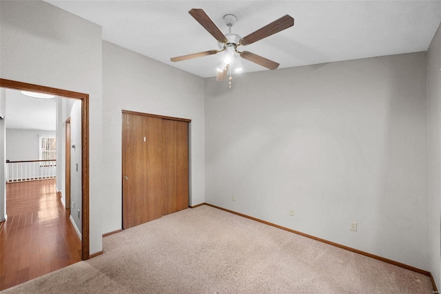 unfurnished bedroom with ceiling fan, a closet, and hardwood / wood-style flooring