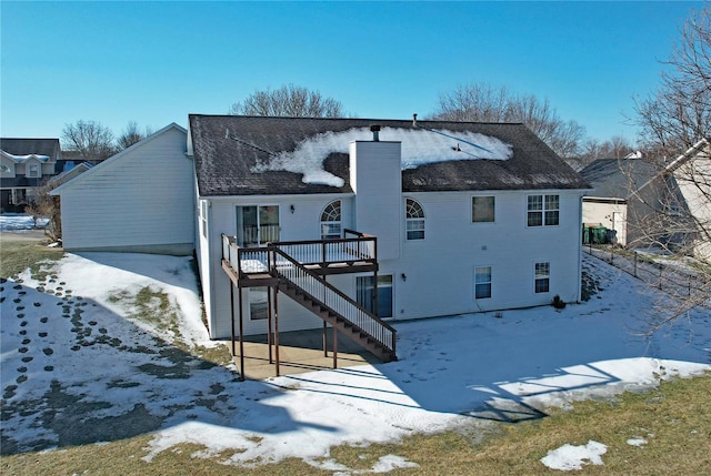 snow covered property featuring a deck