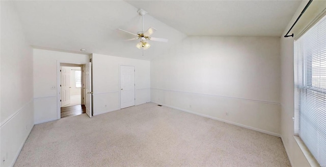 unfurnished bedroom featuring light carpet, multiple windows, a closet, and ceiling fan