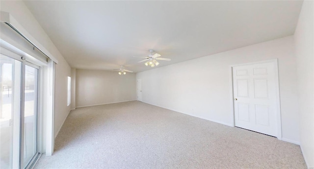 unfurnished room with ceiling fan and light carpet