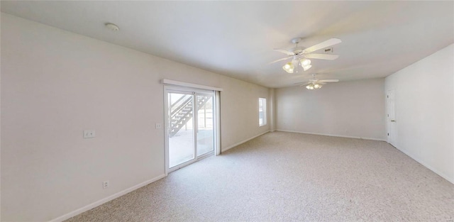 carpeted spare room featuring ceiling fan