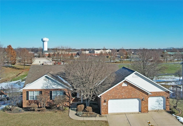 view of front of home with a garage and a front lawn