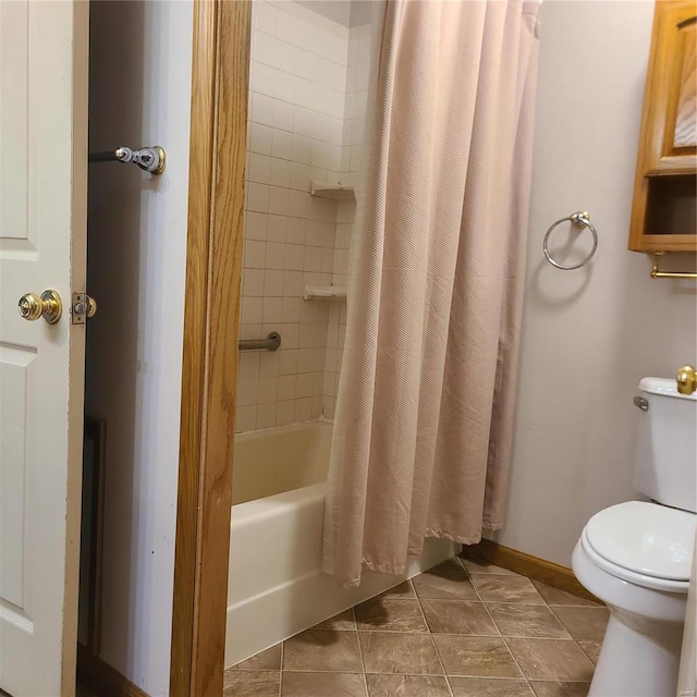 bathroom with tile patterned flooring, shower / bath combo, and toilet