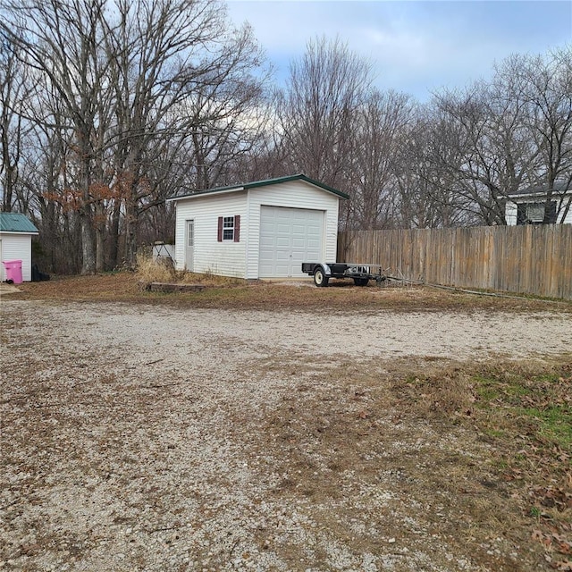 exterior space featuring a garage and an outdoor structure