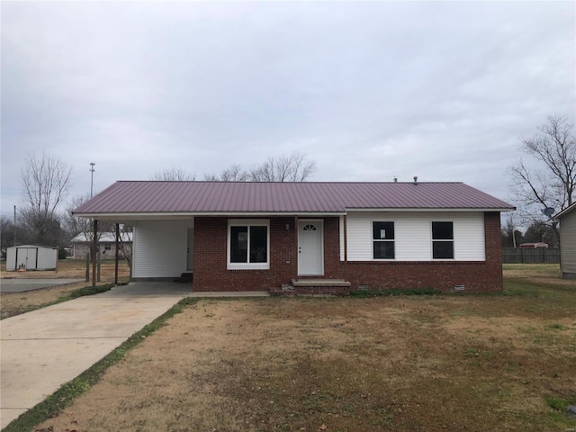 single story home with a front lawn, a shed, and a carport