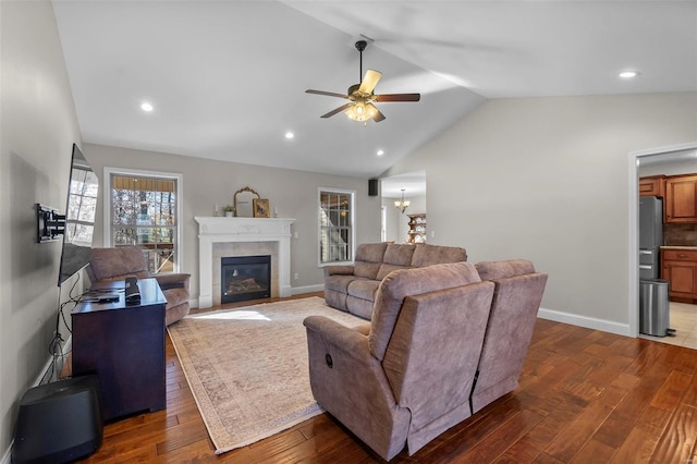 living room featuring plenty of natural light, dark wood-type flooring, and vaulted ceiling