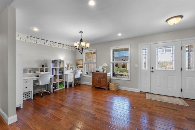 entryway featuring dark wood-type flooring and a chandelier