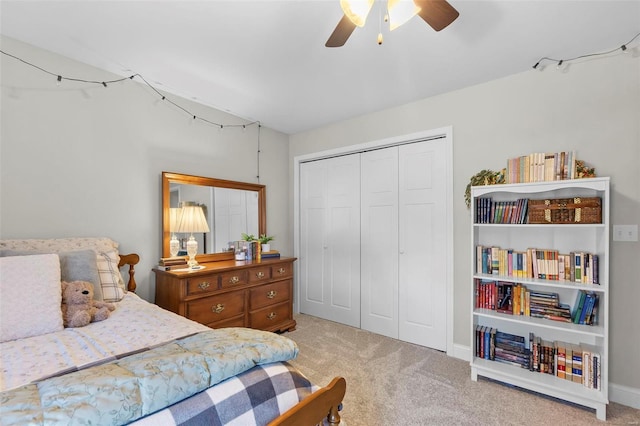 carpeted bedroom featuring ceiling fan and a closet