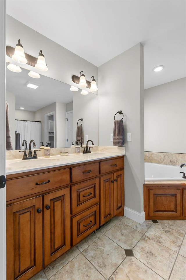 bathroom with a bath, vanity, and tile patterned floors