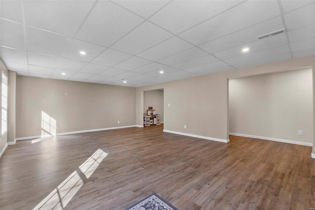 interior space with hardwood / wood-style flooring and a drop ceiling