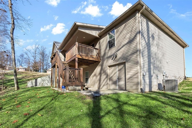 back of property with central air condition unit, a yard, and a wooden deck