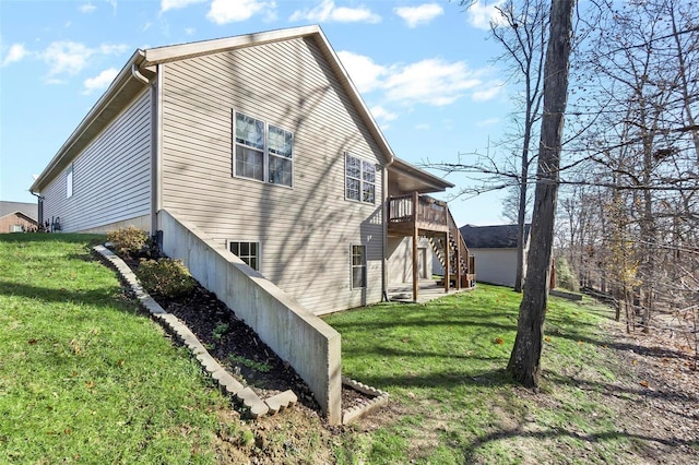 view of property exterior featuring a yard and a wooden deck