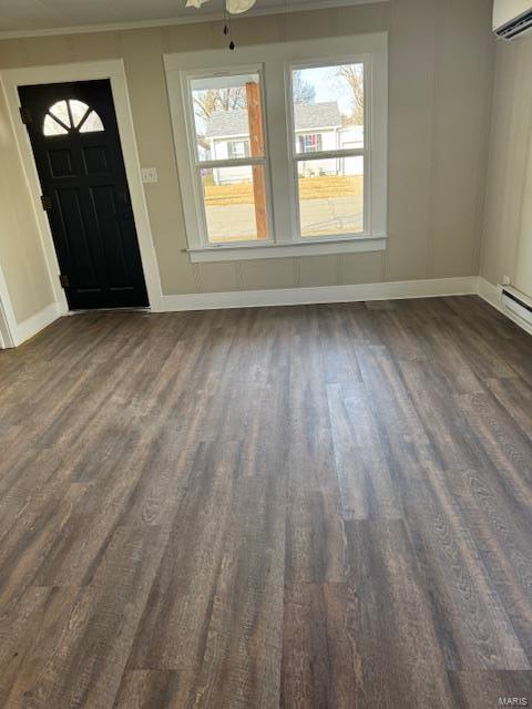 foyer entrance featuring dark hardwood / wood-style floors, ceiling fan, an AC wall unit, and ornamental molding