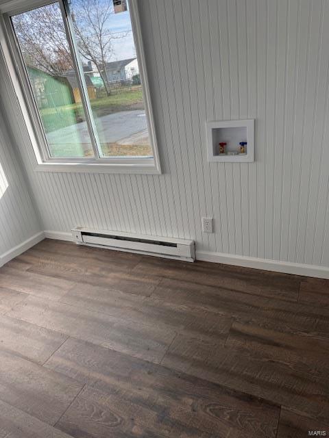 washroom with hookup for a washing machine, a baseboard radiator, and wood-type flooring