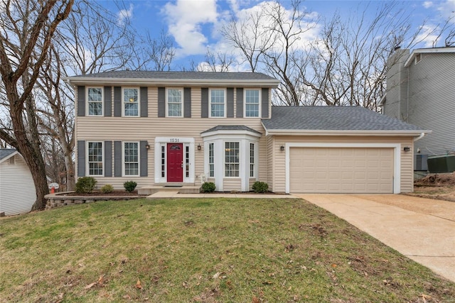 colonial-style house with a garage and a front yard