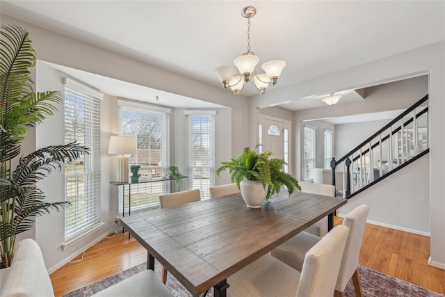 dining area featuring a notable chandelier and light wood-type flooring