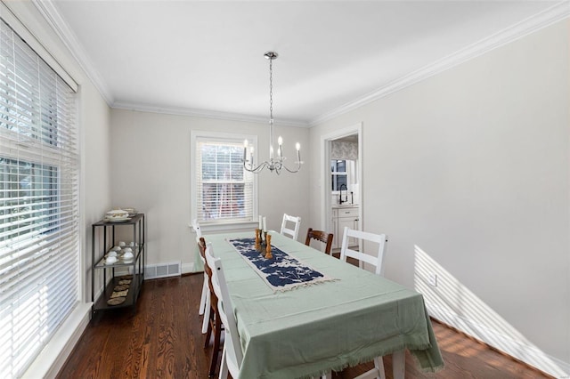 dining room with a notable chandelier, crown molding, and dark hardwood / wood-style floors