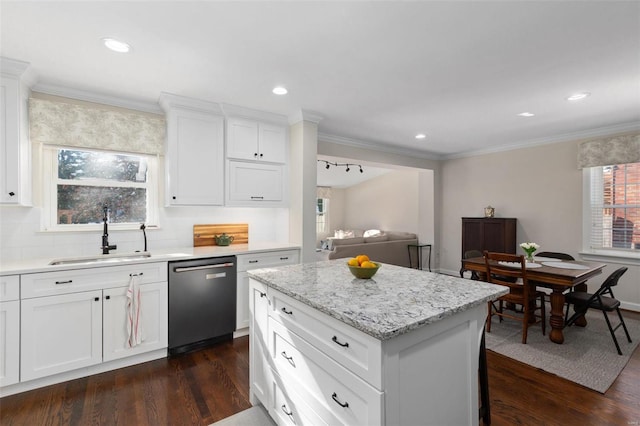 kitchen featuring sink, white cabinetry, tasteful backsplash, dishwasher, and a kitchen island