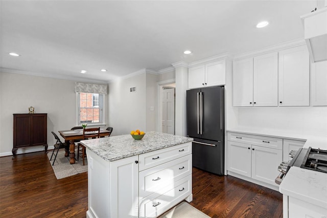 kitchen with a kitchen island, dark hardwood / wood-style floors, high end refrigerator, white cabinets, and light stone countertops