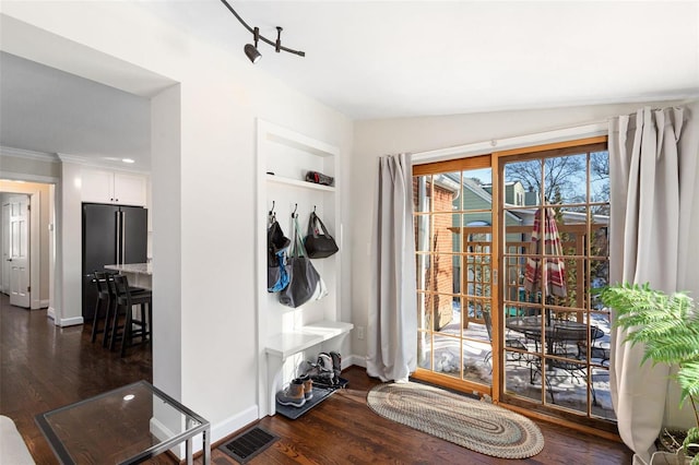 mudroom with vaulted ceiling, built in features, and dark hardwood / wood-style floors