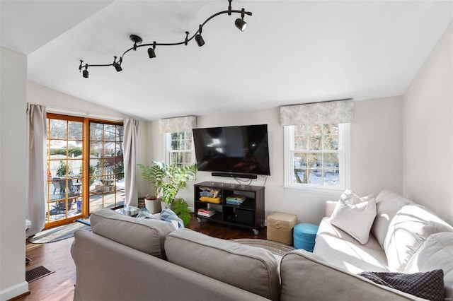 living room with hardwood / wood-style flooring and vaulted ceiling