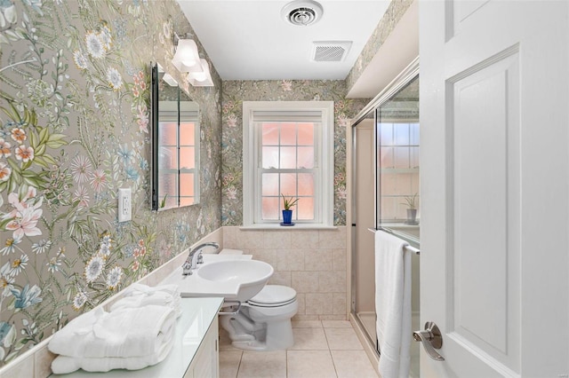 bathroom featuring walk in shower, vanity, toilet, and tile patterned flooring