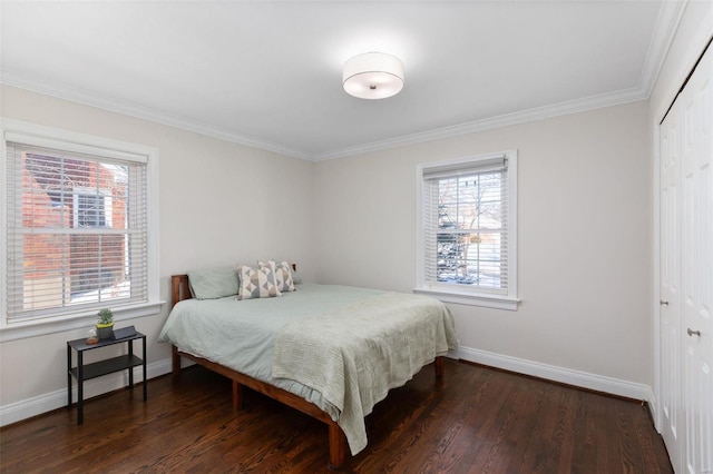 bedroom featuring dark hardwood / wood-style floors, ornamental molding, and a closet