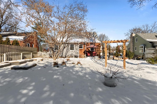 snow covered property with a pergola