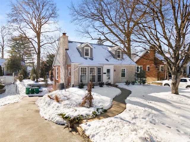 snow covered rear of property with central AC unit