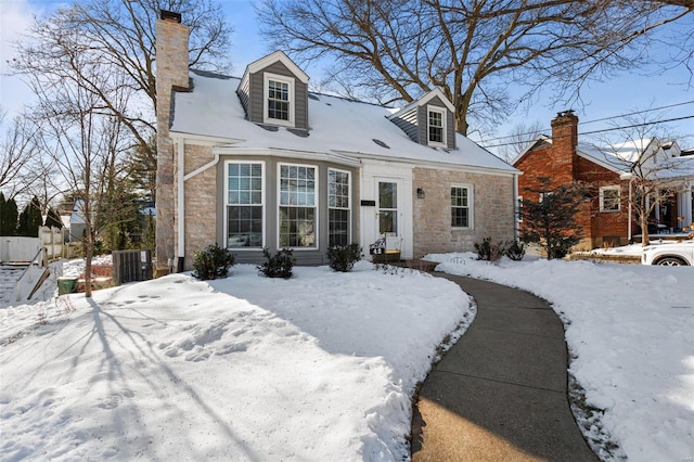 cape cod home featuring central AC