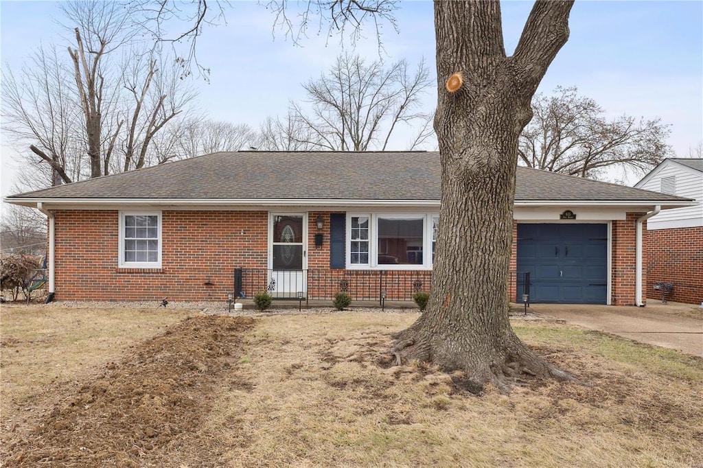 single story home with a garage and a front lawn