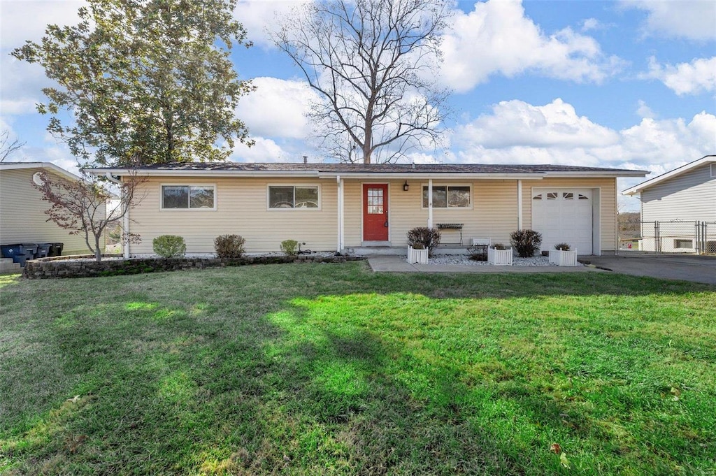 single story home with covered porch, a garage, and a front lawn