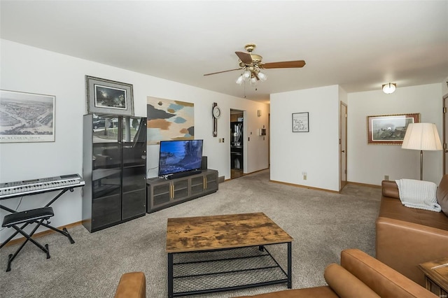 living room featuring ceiling fan and carpet