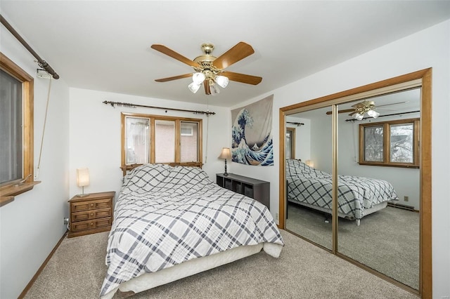 carpeted bedroom featuring ceiling fan and a closet