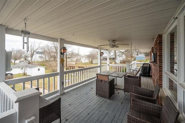 wooden terrace featuring ceiling fan