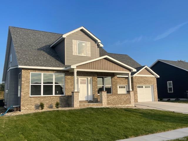 craftsman house with cooling unit, a garage, and a front lawn