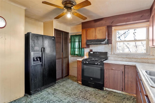 kitchen featuring tasteful backsplash, wooden walls, black appliances, and ceiling fan