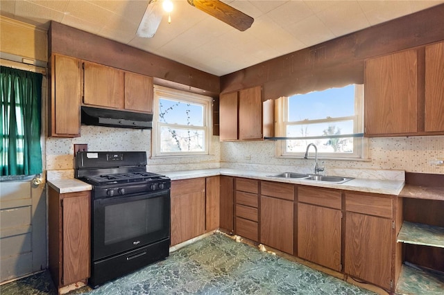 kitchen with tasteful backsplash, a healthy amount of sunlight, black range with gas stovetop, and sink