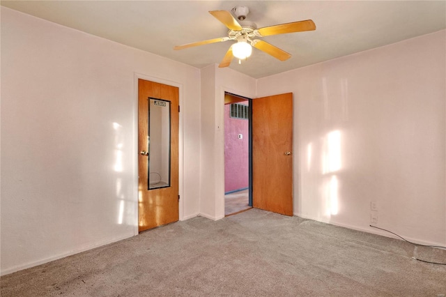 carpeted empty room featuring ceiling fan