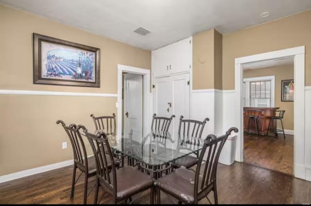 dining space featuring dark hardwood / wood-style floors